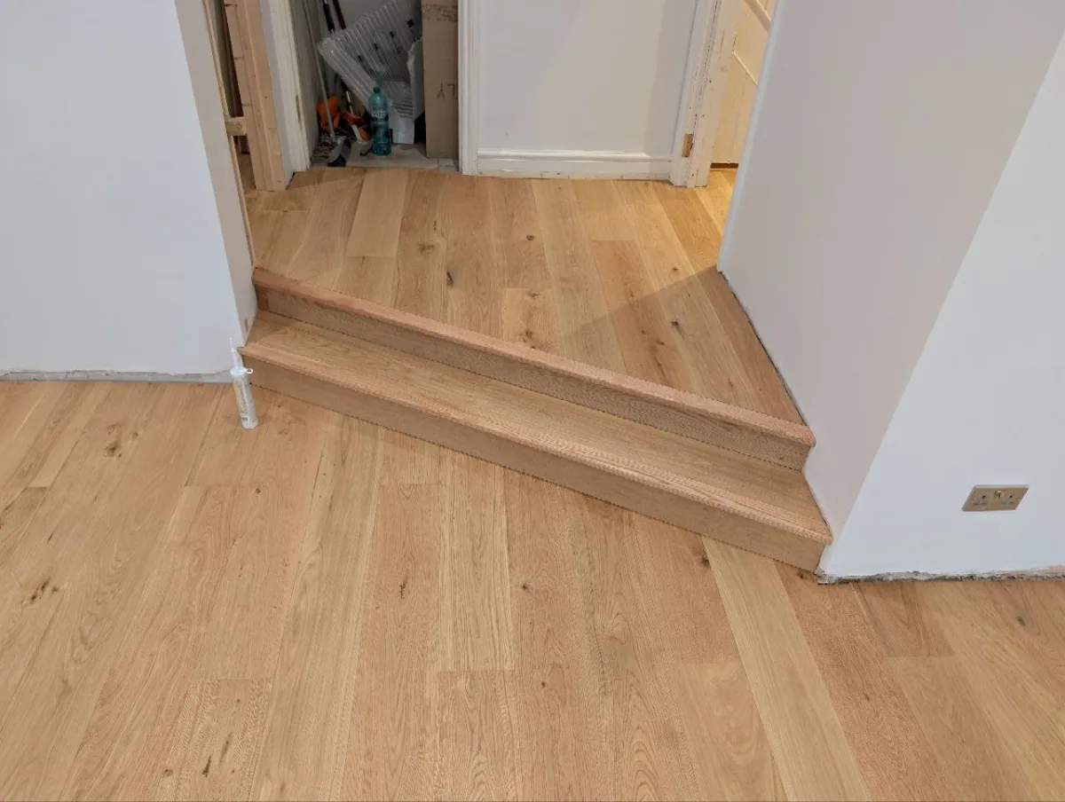 A step down into a Dulwich extension, built from the same oak boards as the floor