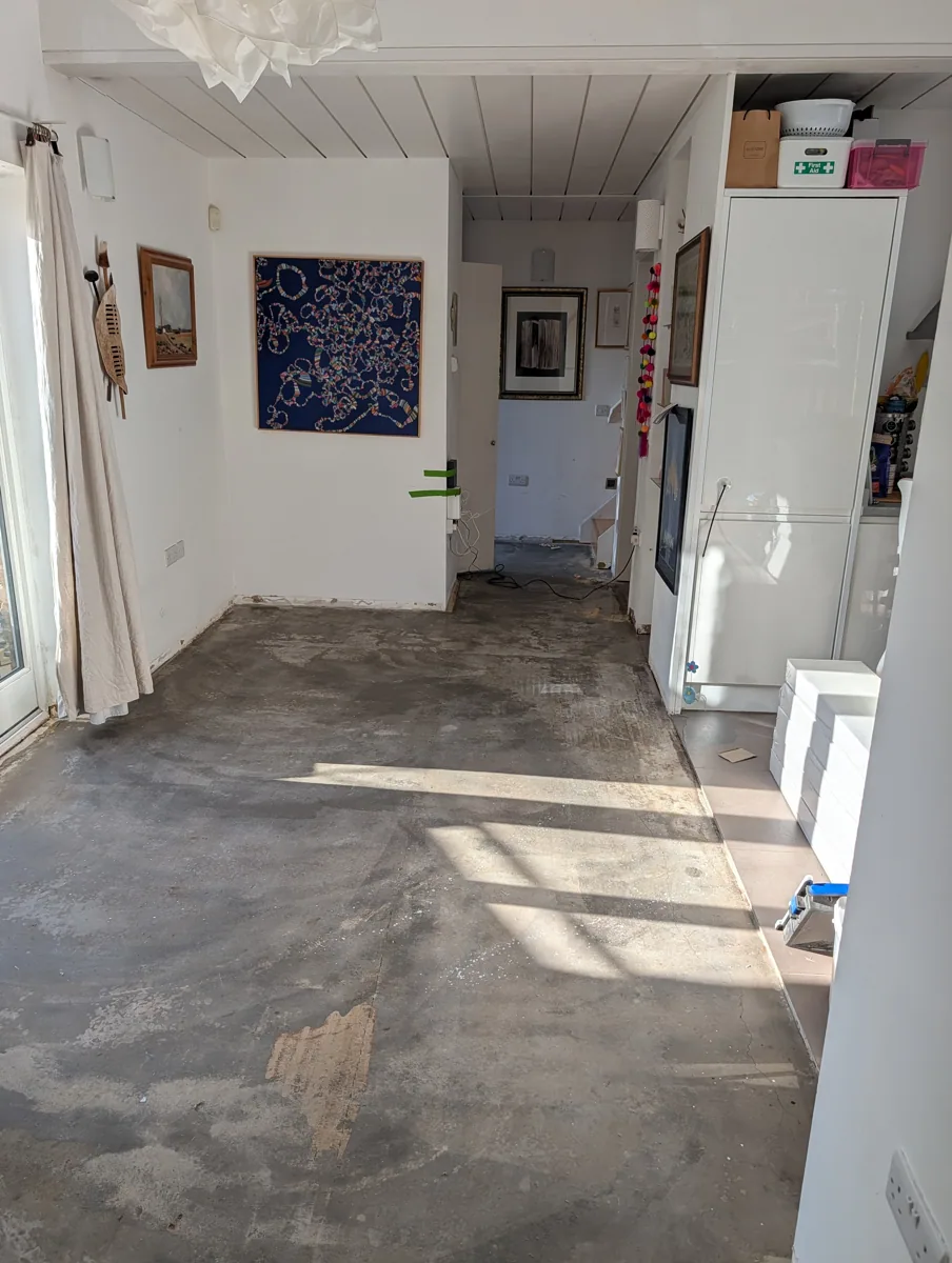 Bare concrete screed in a through room in Honor Oak before the new oak floor was laid