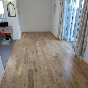 Natural oak plank flooring by the garden doors of a house in Honor Oak