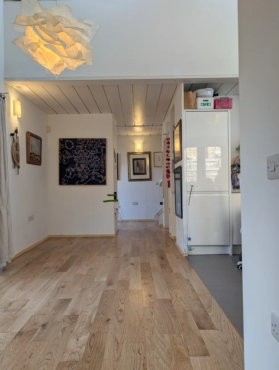 The same through room in Honor Oak after natural oak plank flooring was laid